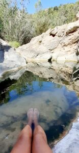 Jennifer has her feet in the small pool above the Gorg del Salt waterfall