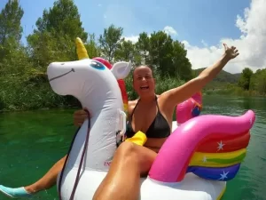 Jennifer is white water rafting on a unicorn in the Júcar river