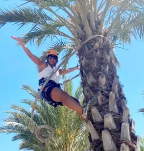 Wild Child Costa Blanca climbing a palm tree in Elche